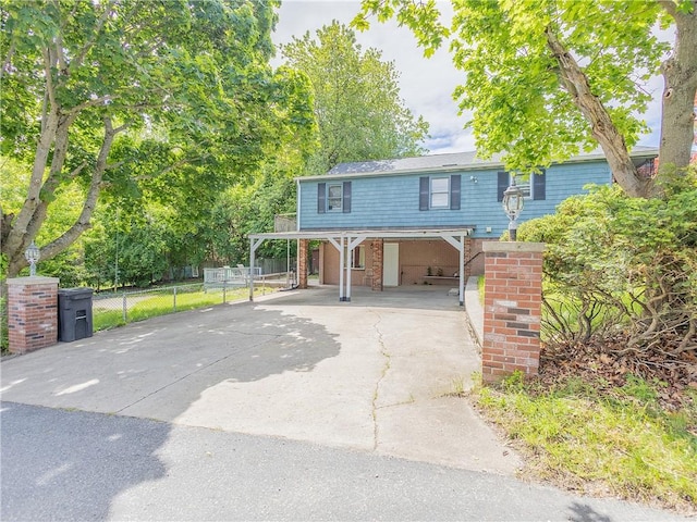 79 George Waterman Rd, Johnston, RI 02919 - traditional home featuring a carport, driveway, and brick siding