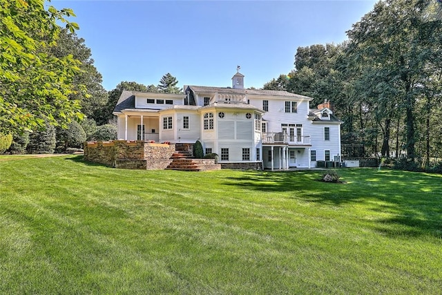 45 Burns Way E, Greenwich, RI 02818 - back of property featuring a chimney and a lawn