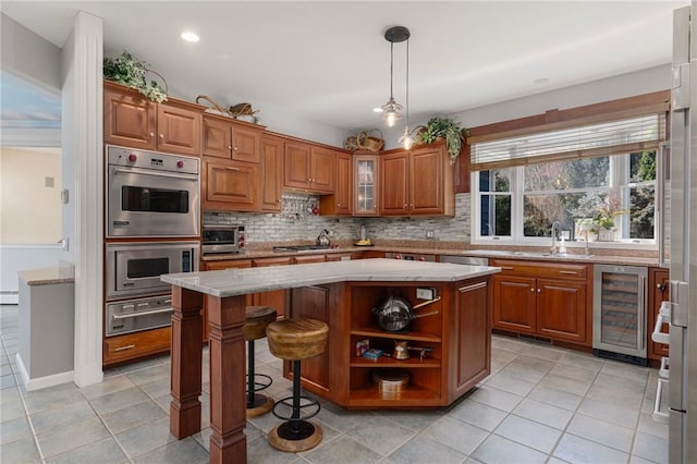 95 Pheasant Dr, East Greenwich, RI 02818 - kitchen featuring beverage cooler, a warming drawer, light tile patterned flooring, brown cabinets, and backsplash