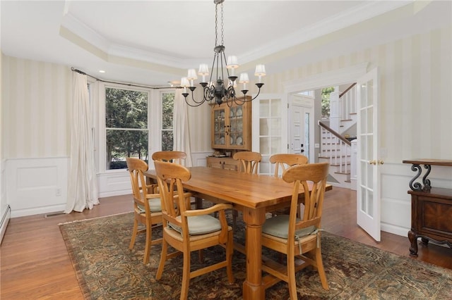 95 Pheasant Dr, East Greenwich, RI 02818 - dining area featuring wallpapered walls, a chandelier, crown molding, a raised ceiling, and wood finished floors