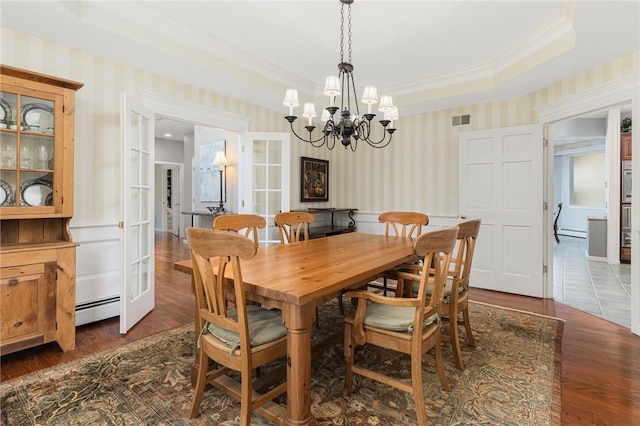 95 Pheasant Dr, East Greenwich, RI 02818 - dining space with wallpapered walls, a baseboard heating unit, a chandelier, crown molding, and dark wood-type flooring