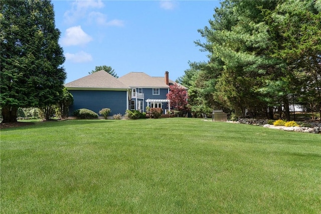 95 Pheasant Dr, East Greenwich, RI 02818 - view of front of house featuring a front yard and a chimney