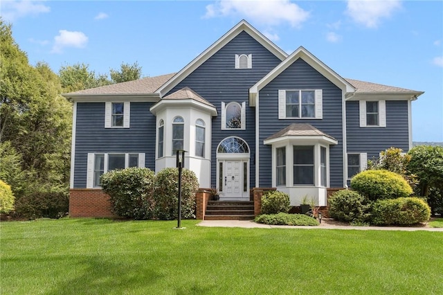 95 Pheasant Dr, East Greenwich, RI 02818 - view of front facade featuring a front lawn and roof with shingles