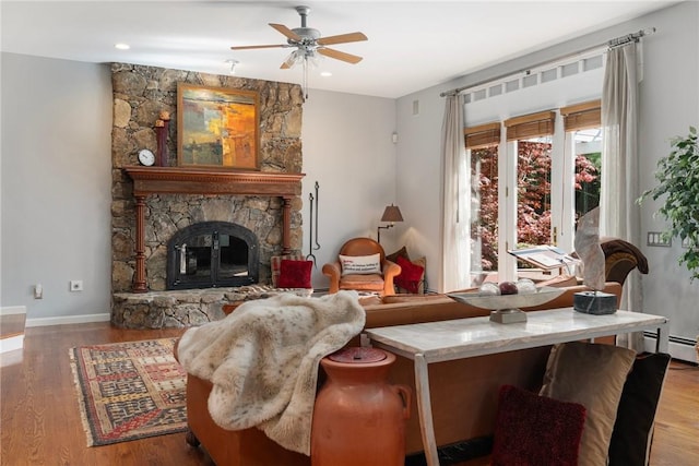 95 Pheasant Dr, East Greenwich, RI 02818 - living room featuring wood finished floors, a ceiling fan, a stone fireplace, a baseboard heating unit, and recessed lighting
