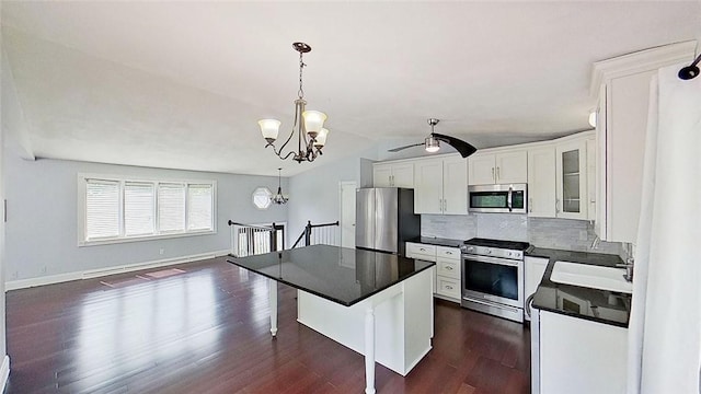 370 Ring Ave, Warwick, RI 02888 - kitchen featuring stainless steel appliances, dark countertops, white cabinets, a ceiling fan, and lofted ceiling
