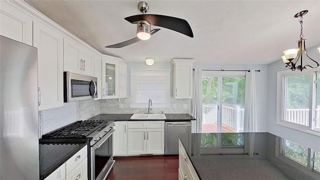 370 Ring Ave, Warwick, RI 02888 - kitchen featuring appliances with stainless steel finishes, a sink, dark countertops, and tasteful backsplash