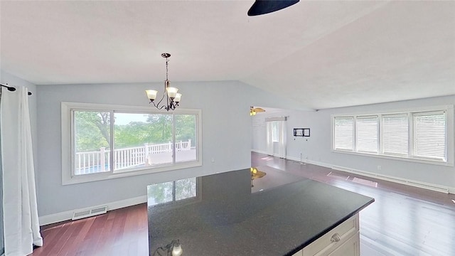 370 Ring Ave, Warwick, RI 02888 - kitchen featuring dark wood finished floors, a chandelier, dark countertops, vaulted ceiling, and open floor plan