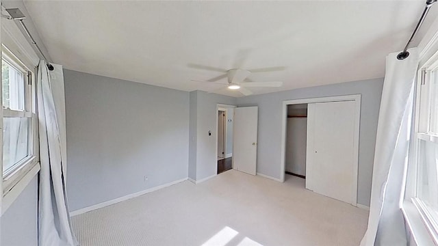 370 Ring Ave, Warwick, RI 02888 - unfurnished bedroom featuring light colored carpet, baseboards, ceiling fan, and a closet