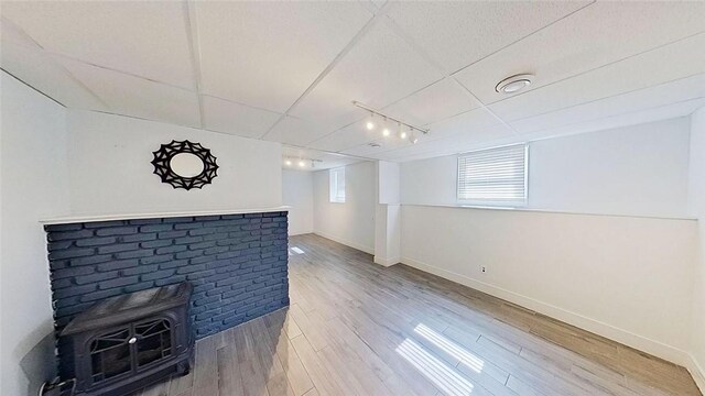 370 Ring Ave, Warwick, RI 02888 - unfurnished living room featuring light wood-type flooring, a wood stove, and baseboards