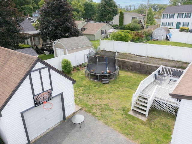 254 Jenckes St, Woonsocket, RI 02895 - view of yard with a trampoline, a deck, a residential view, an outdoor structure, and a garage
