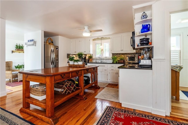 170 Pilgrim Pkwy, Warwick, RI 02888 - kitchen featuring freestanding refrigerator, dark countertops, plenty of natural light, and white cabinetry