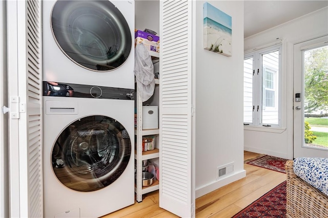 170 Pilgrim Pkwy, Warwick, RI 02888 - laundry room featuring stacked washer / drying machine, wood finished floors, crown molding, and baseboards