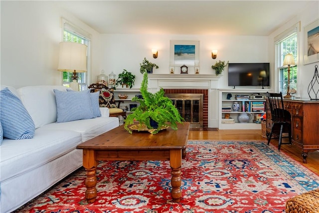 170 Pilgrim Pkwy, Warwick, RI 02888 - living area featuring healthy amount of natural light, a fireplace, and wood finished floors