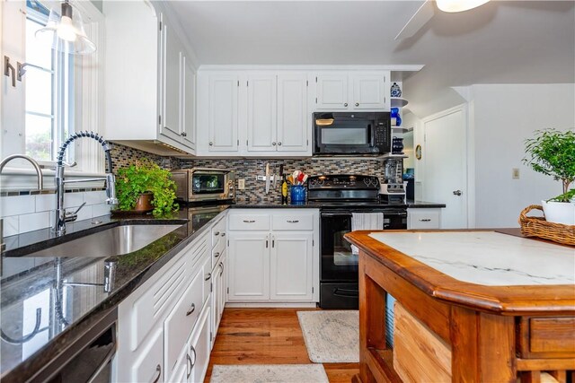 170 Pilgrim Pkwy, Warwick, RI 02888 - kitchen with black appliances, a sink, decorative backsplash, and white cabinets