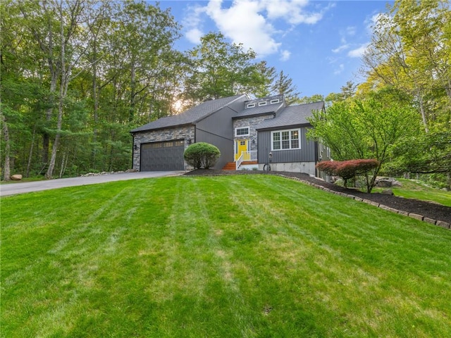 511 Central Pike, Scituate, RI 02857 - view of front facade featuring driveway, stone siding, an attached garage, and a front lawn