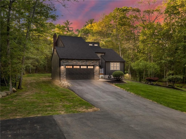 511 Central Pike, Scituate, RI 02857 - view of front of house featuring stone siding, asphalt driveway, an attached garage, a chimney, and a front yard