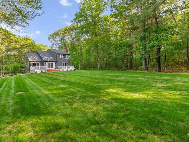 511 Central Pike, Scituate, RI 02857 - view of green lawn featuring a sunroom, a deck, and a view of trees