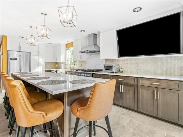 511 Central Pike, Scituate, RI 02857 - kitchen featuring exhaust hood, built in fridge, a chandelier, a center island, and tasteful backsplash