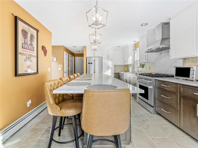 511 Central Pike, Scituate, RI 02857 - kitchen featuring appliances with stainless steel finishes, a baseboard radiator, wall chimney range hood, and tasteful backsplash