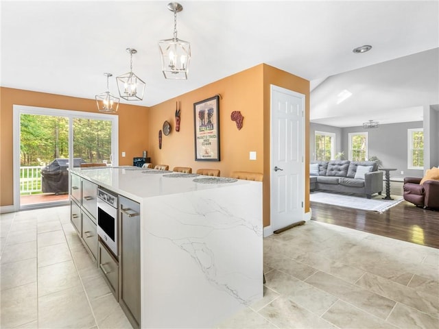 511 Central Pike, Scituate, RI 02857 - kitchen with a chandelier, decorative light fixtures, open floor plan, a kitchen island, and baseboards