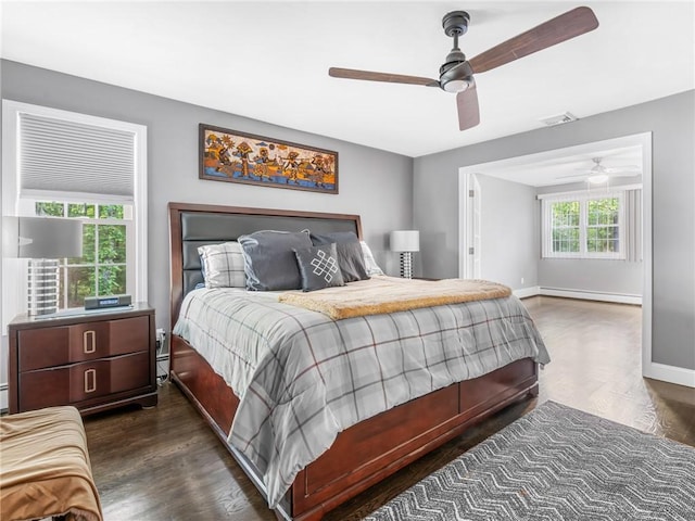 511 Central Pike, Scituate, RI 02857 - bedroom featuring a baseboard heating unit, dark wood-style flooring, baseboards, and ceiling fan