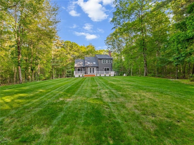 511 Central Pike, Scituate, RI 02857 - rear view of property with a sunroom, a lawn, a chimney, and a wooded view