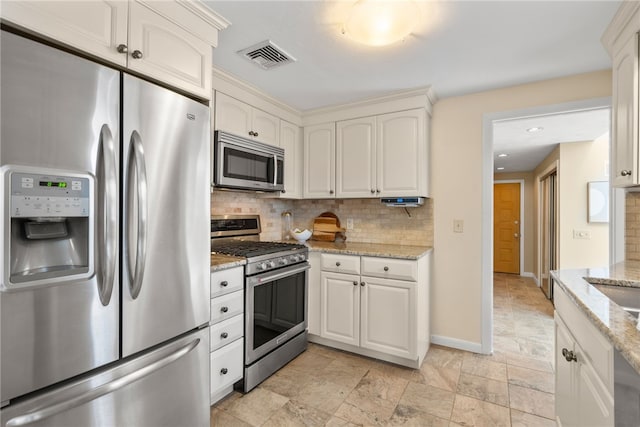 45 Landon Rd, Warwick, RI 02888 - kitchen with stainless steel appliances, backsplash, baseboards, light stone counters, and light stone finish floors