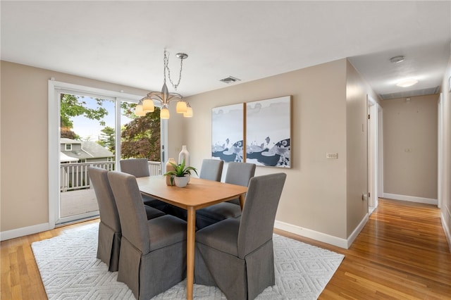 45 Landon Rd, Warwick, RI 02888 - dining room with attic access, baseboards, light wood finished floors, and a chandelier