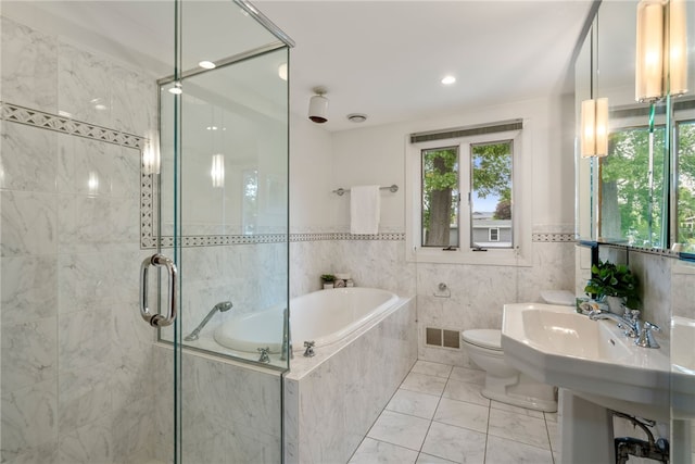 45 Landon Rd, Warwick, RI 02888 - bathroom featuring plenty of natural light, a garden tub, toilet, a stall shower, and tile walls