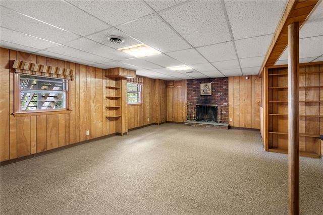 45 Landon Rd, Warwick, RI 02888 - basement with a fireplace, a paneled ceiling, wooden walls, and baseboards
