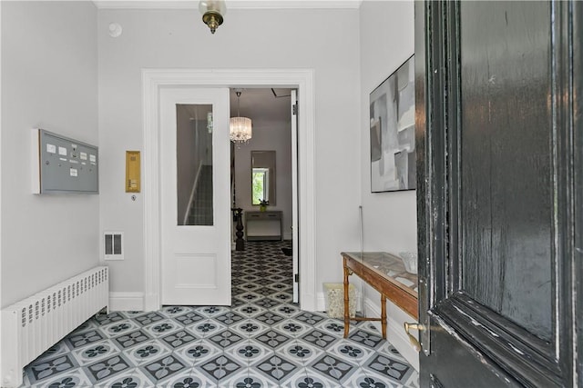 4 Red Cross Ave Unit 4, Newport, RI 02840 - corridor with radiator, baseboards, light flooring, and a chandelier