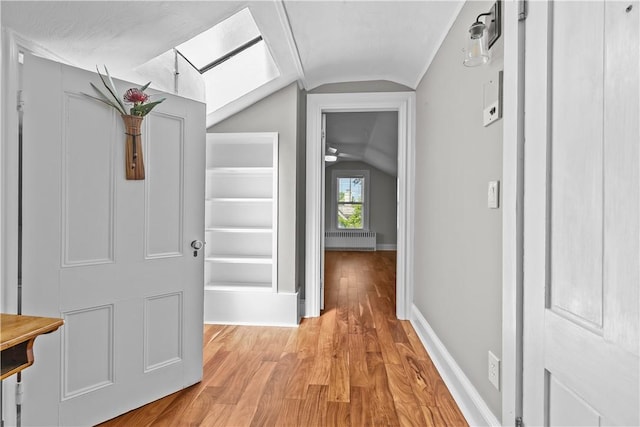 4 Red Cross Ave Unit 4, Newport, RI 02840 - corridor featuring vaulted ceiling, radiator, light wood-type flooring, baseboards, and a skylight