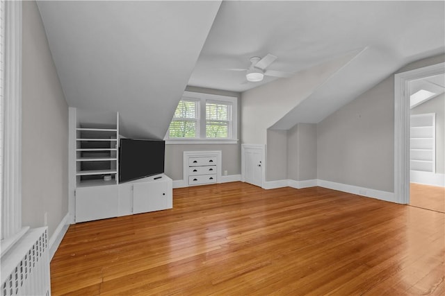 4 Red Cross Ave Unit 4, Newport, RI 02840 - unfurnished living room with radiator heating unit, vaulted ceiling, light wood-style flooring, and ceiling fan