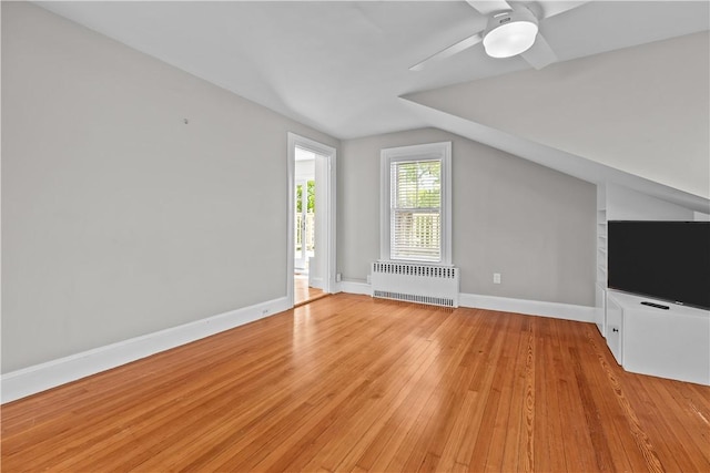 4 Red Cross Ave Unit 4, Newport, RI 02840 - unfurnished living room with radiator, light wood-type flooring, baseboards, ceiling fan, and lofted ceiling