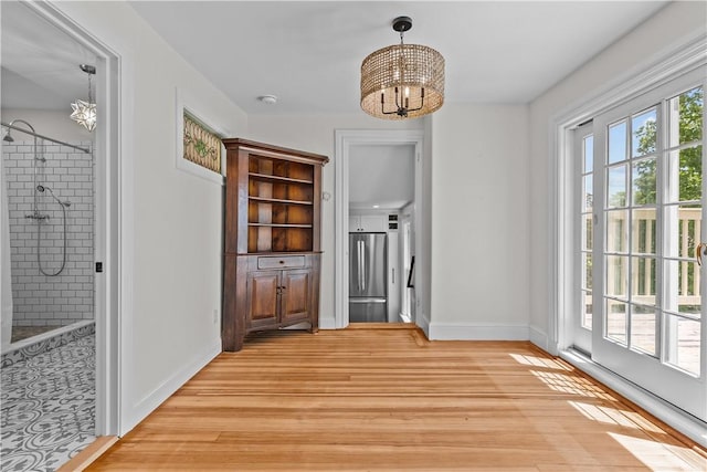 4 Red Cross Ave Unit 4, Newport, RI 02840 - unfurnished dining area with a chandelier, baseboards, and light wood finished floors