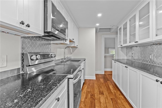 4 Red Cross Ave Unit 4, Newport, RI 02840 - kitchen with stainless steel appliances, a sink, white cabinets, light wood-type flooring, and recessed lighting