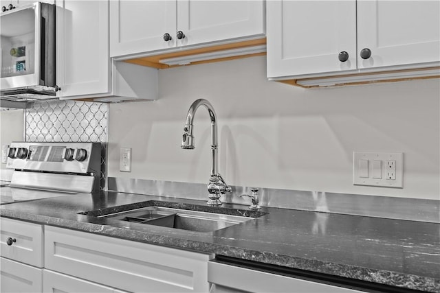4 Red Cross Ave Unit 4, Newport, RI 02840 - kitchen with stainless steel appliances, a sink, white cabinetry, decorative backsplash, and dark stone countertops