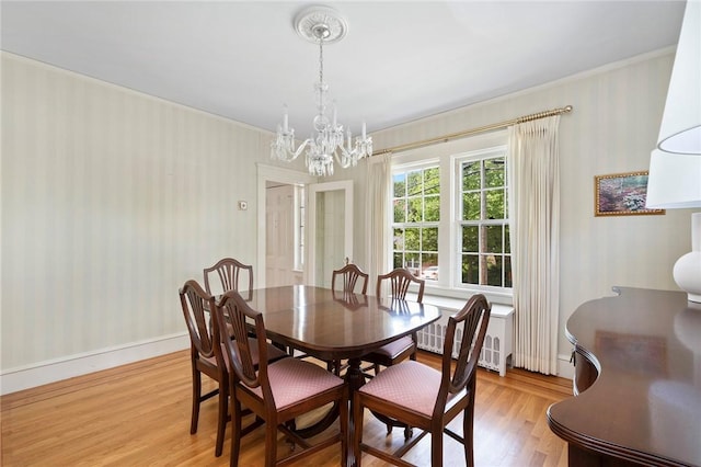 47 Lyndhurst Ave, Providence, RI 02908 - dining space featuring wallpapered walls, light wood-style flooring, a chandelier, ornamental molding, and radiator