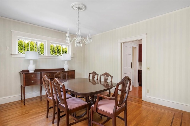 47 Lyndhurst Ave, Providence, RI 02908 - dining area featuring a chandelier, light wood finished floors, baseboards, ornamental molding, and wallpapered walls