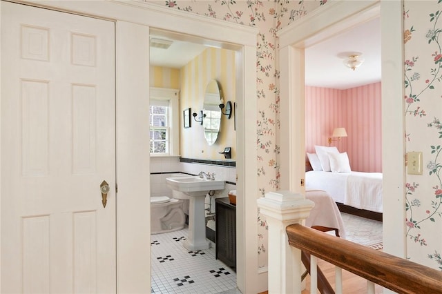 47 Lyndhurst Ave, Providence, RI 02908 - bathroom featuring wallpapered walls, tile patterned flooring, toilet, and a sink