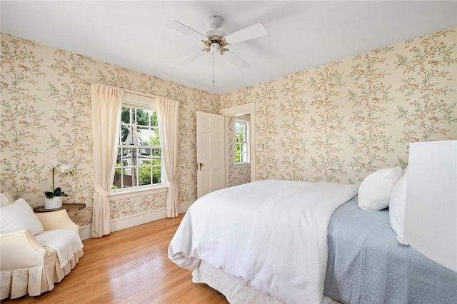 47 Lyndhurst Ave, Providence, RI 02908 - bedroom with light wood-type flooring, baseboards, a ceiling fan, and wallpapered walls