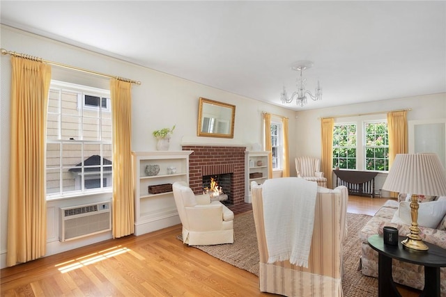 47 Lyndhurst Ave, Providence, RI 02908 - living area with a wall mounted air conditioner, a chandelier, light wood-type flooring, and a fireplace