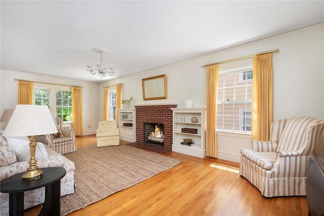 47 Lyndhurst Ave, Providence, RI 02908 - living room with a chandelier, wood finished floors, baseboards, and a fireplace
