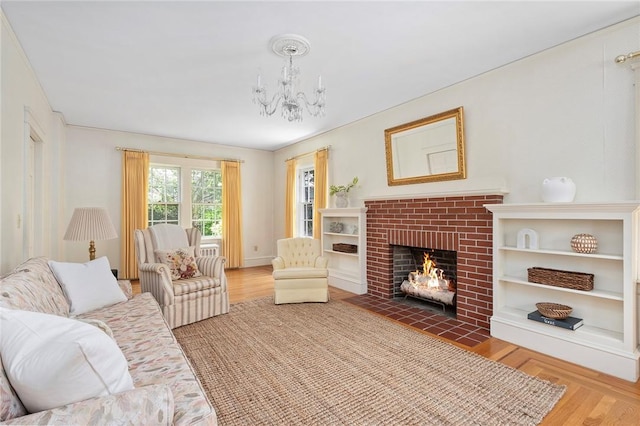47 Lyndhurst Ave, Providence, RI 02908 - living area with wood finished floors, a chandelier, and a brick fireplace