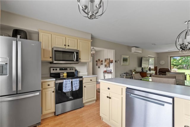 30 Sweet Meadow Ct Unit 15, Narragansett, RI 02882 - kitchen with stainless steel appliances, a chandelier, cream cabinets, and light countertops