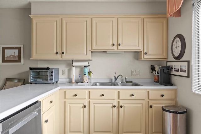 30 Sweet Meadow Ct Unit 15, Narragansett, RI 02882 - kitchen with cream cabinets, stainless steel dishwasher, a sink, and light countertops