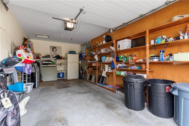 30 Sweet Meadow Ct Unit 15, Narragansett, RI 02882 - garage featuring freestanding refrigerator and a garage door opener