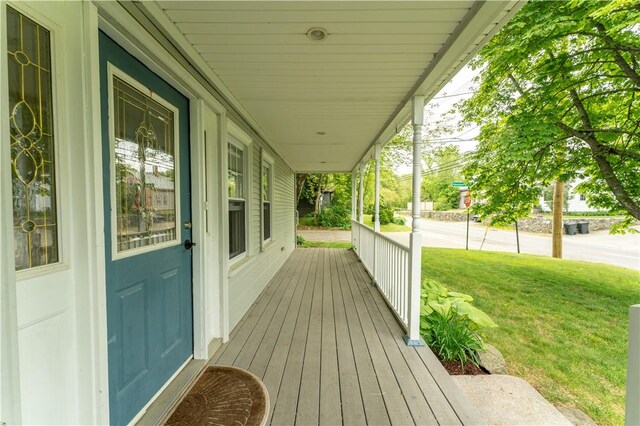 235 Spring St, Hopkinton, RI 02832 - wooden porch featuring a yard