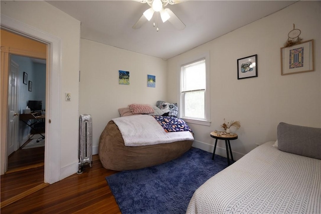 16 Malvern Ave, Cranston, RI 02905 - bedroom with wood finished floors, baseboards, radiator heating unit, ceiling fan, and a desk