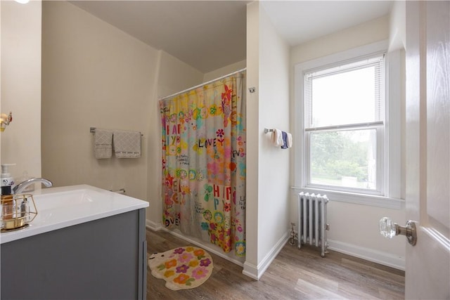 16 Malvern Ave, Cranston, RI 02905 - bathroom featuring radiator heating unit, wood finished floors, a shower with curtain, baseboards, and vanity
